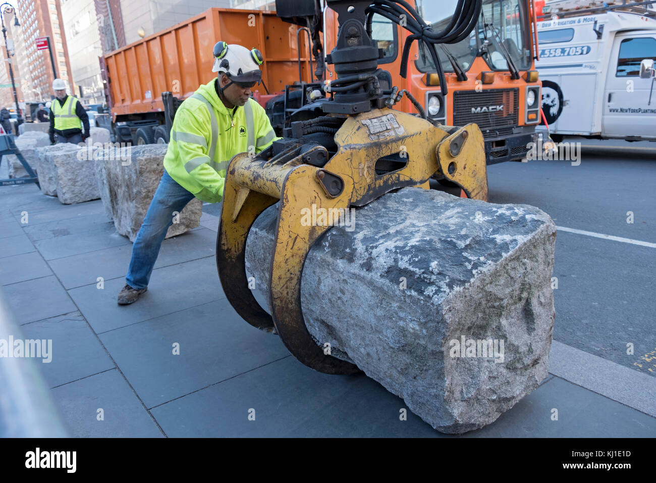 A New York City Parks department worker helps install anti-terror blockades at hte south end of Union Square Park in New York City. Stock Photo