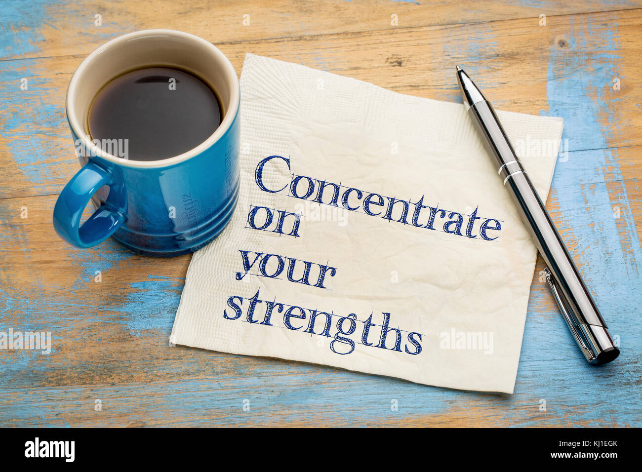Concentrate on your strengths - handwriting on a napkin with a cup of espresso coffee Stock Photo
