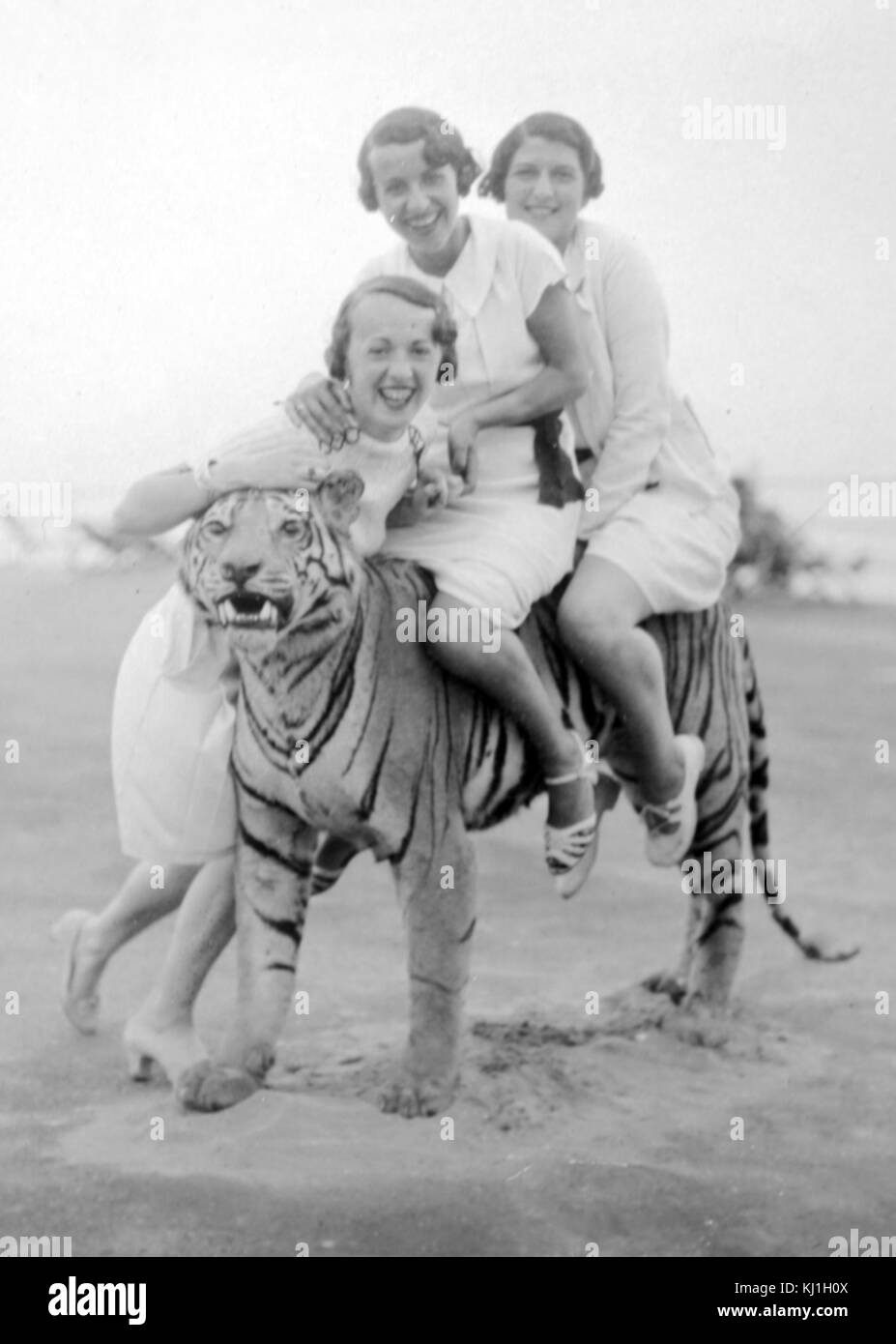 British tourists sitting on a stuffed tiger while on holiday in Italy, just prior to World war Two. 1938 Stock Photo