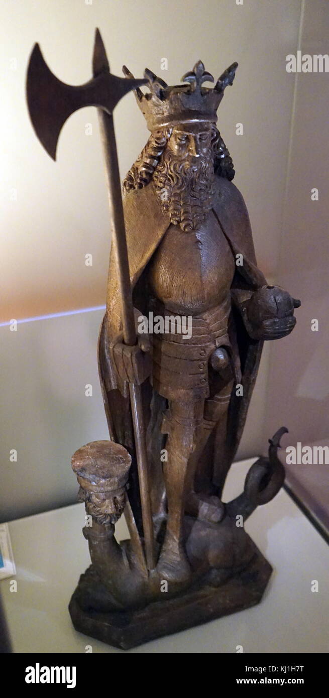 King Olav Haraldsson of Norway, who converted Norwegians to Christianity, died in 1030 ad. Figure of St. Olav, King of Norway, carved in oak and originally painted in various colours. The figure, made in Lübeck, Germany, in the i6th century, depicts him in the armour of that period. He holds his axe Hel (“Death”) and his orb of office, as he tramples the Devil. Stock Photo