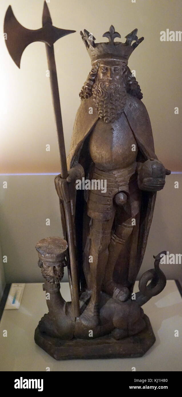 King Olav Haraldsson of Norway, who converted Norwegians to Christianity, died in 1030 ad. Figure of St. Olav, King of Norway, carved in oak and originally painted in various colours. The figure, made in Lübeck, Germany, in the i6th century, depicts him in the armour of that period. He holds his axe Hel (“Death”) and his orb of office, as he tramples the Devil. Stock Photo