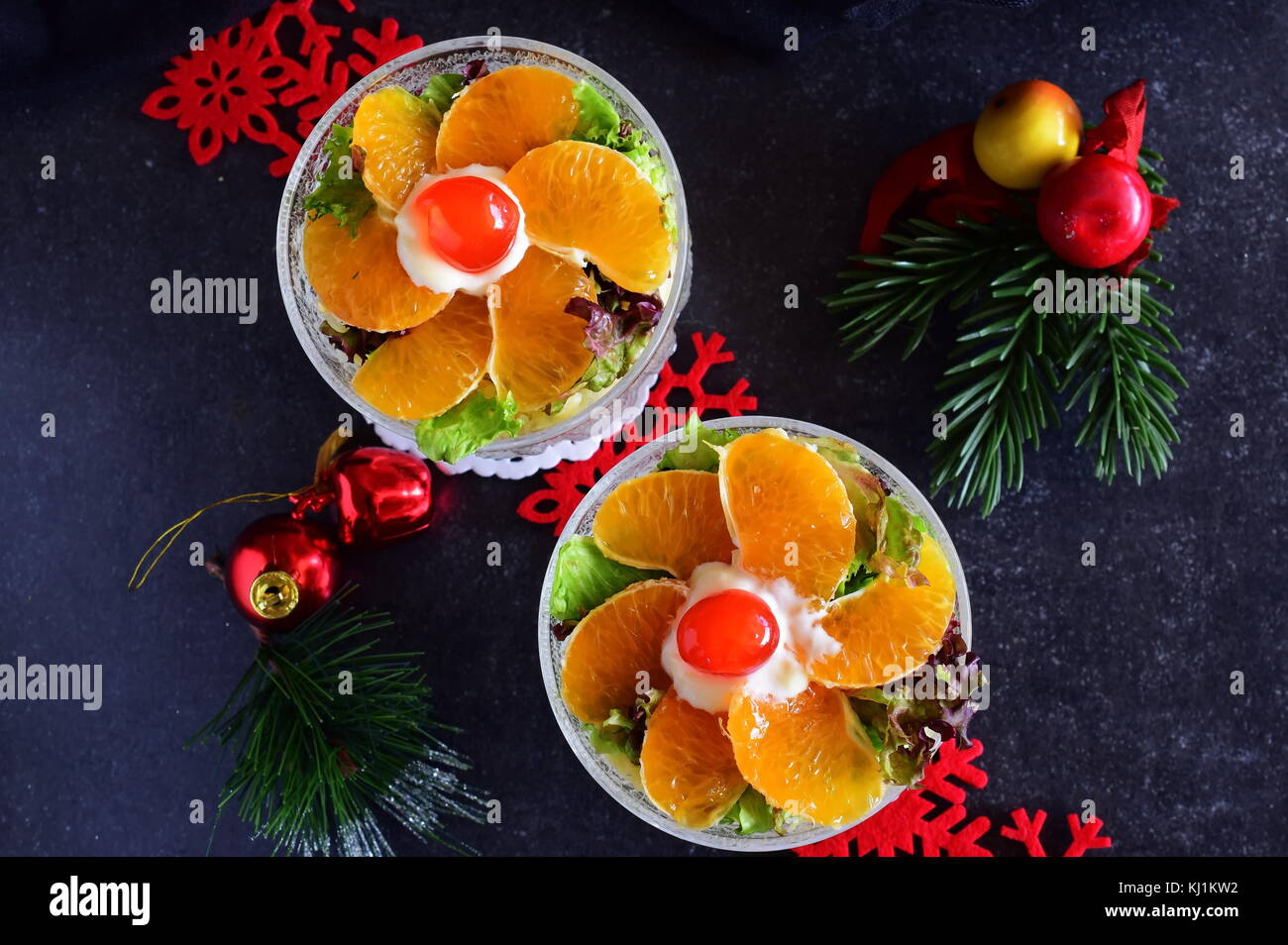 Fresh salad with chicken, banana, cheese, salad leaves,yogurt dressing. Christmas decoration, Holidays New year Stock Photo