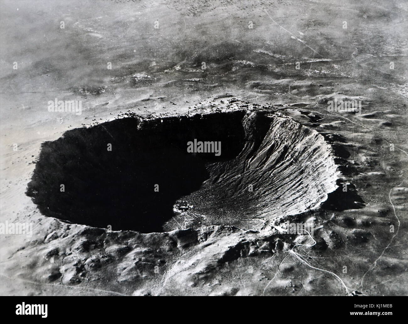 Photograph of the Arizona meteor crater. Meteor Crater is a meteorite impact crater approximately 37 miles (60 km) east of Flagstaff and 18 miles (29 km) west of Winslow in the northern Arizona desert of the United States. Dated 20th Century Stock Photo
