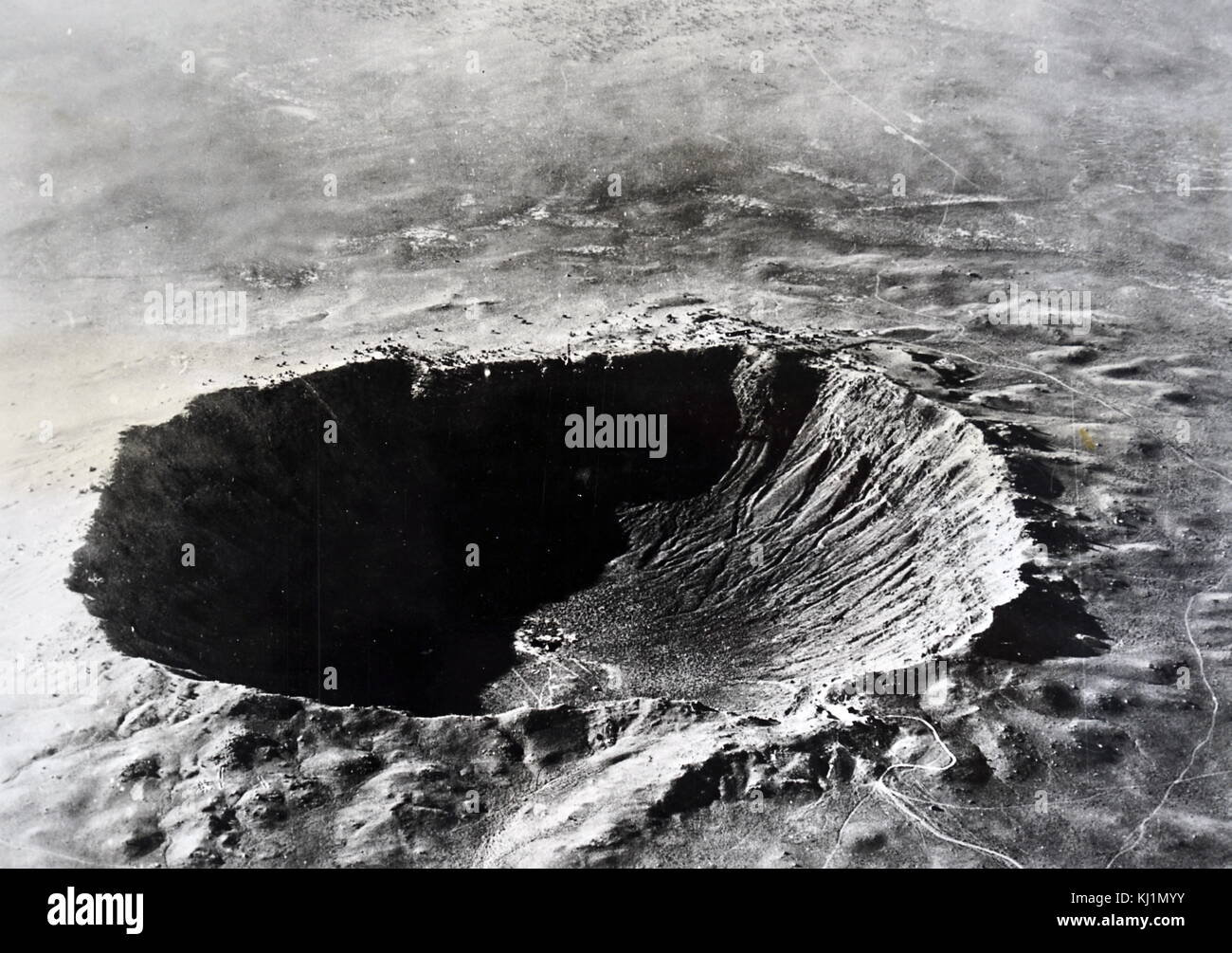 Photograph of the Arizona meteor crater. Meteor Crater is a meteorite impact crater approximately 37 miles (60 km) east of Flagstaff and 18 miles (29 km) west of Winslow in the northern Arizona desert of the United States. Dated 20th Century Stock Photo