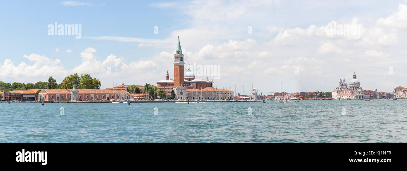 Stitched panorama view of San Giorgio Maggiore, Basino San Marco and Basilica di Santa Maria della Salute, Venice, Veneto,  Italy with light sea mist Stock Photo