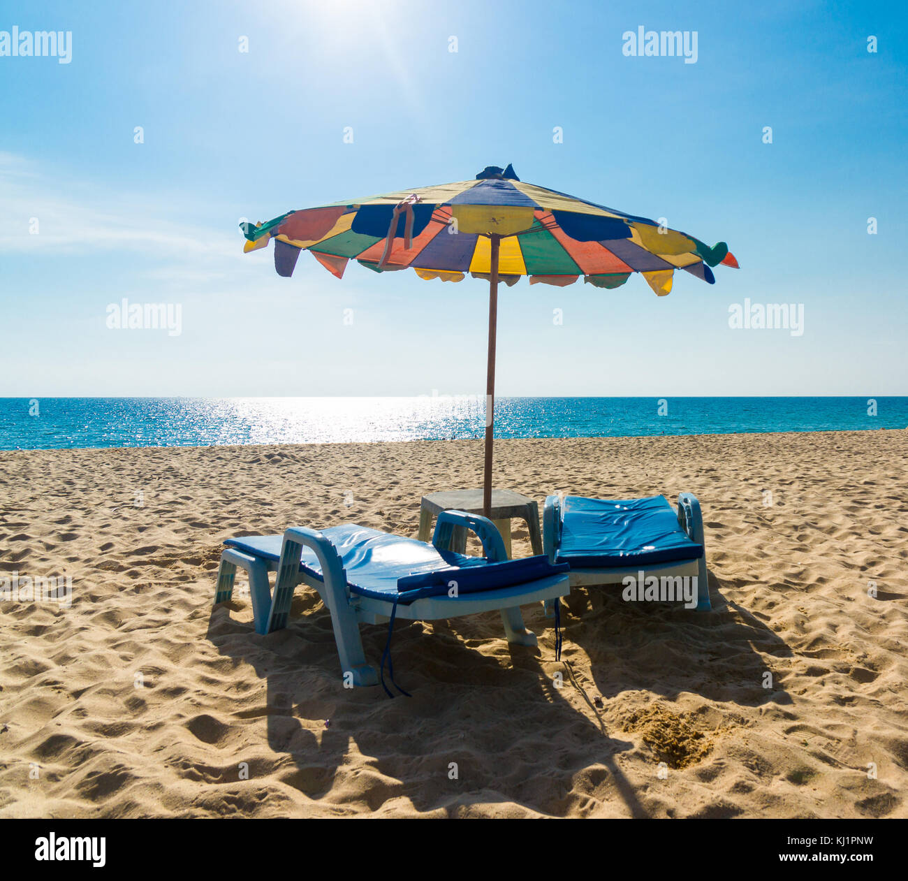 Lounge chairs with sun umbrella on a beach Stock Photo Alamy