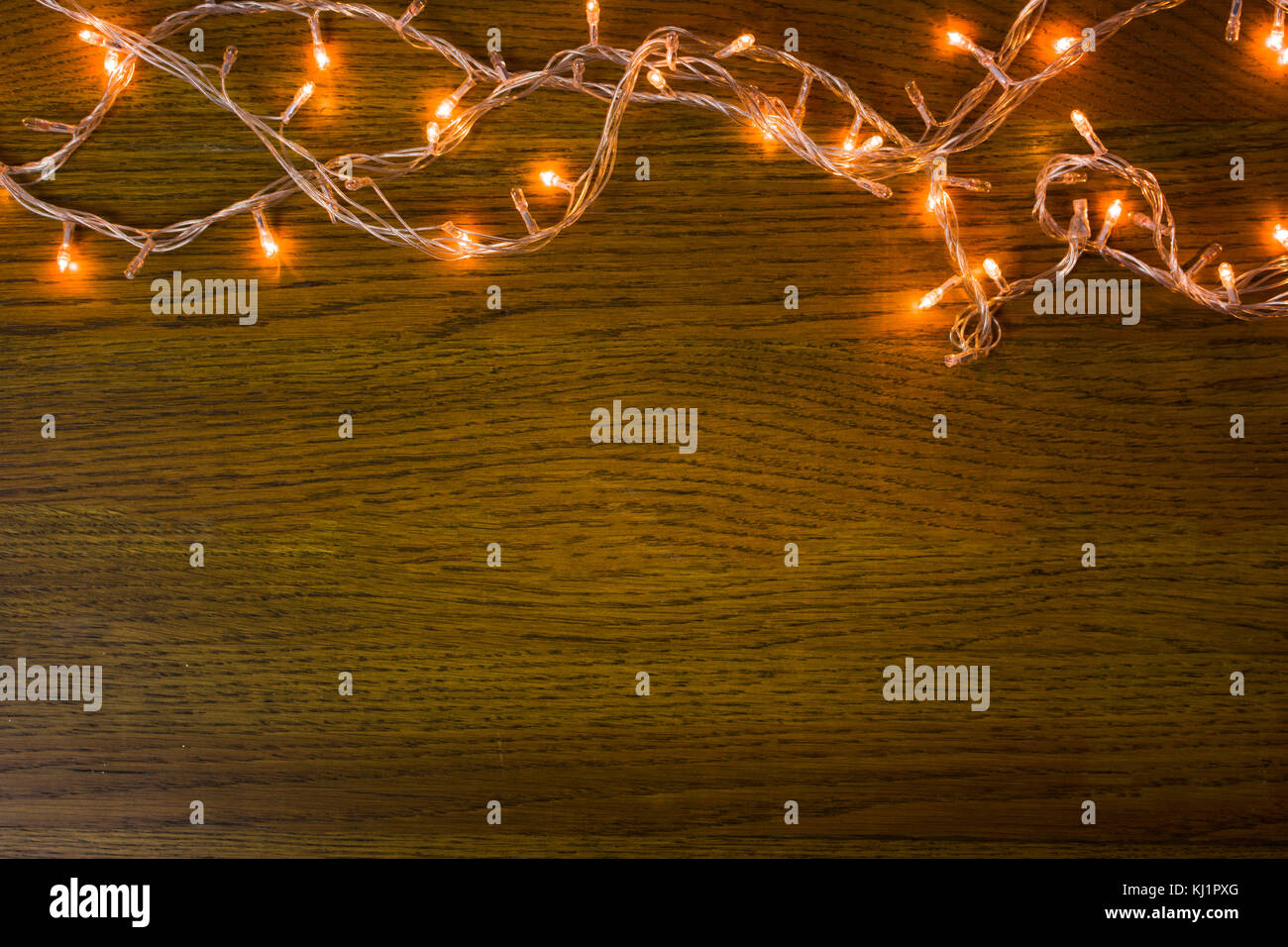 Christmas lights on wooden background with copy space Stock Photo