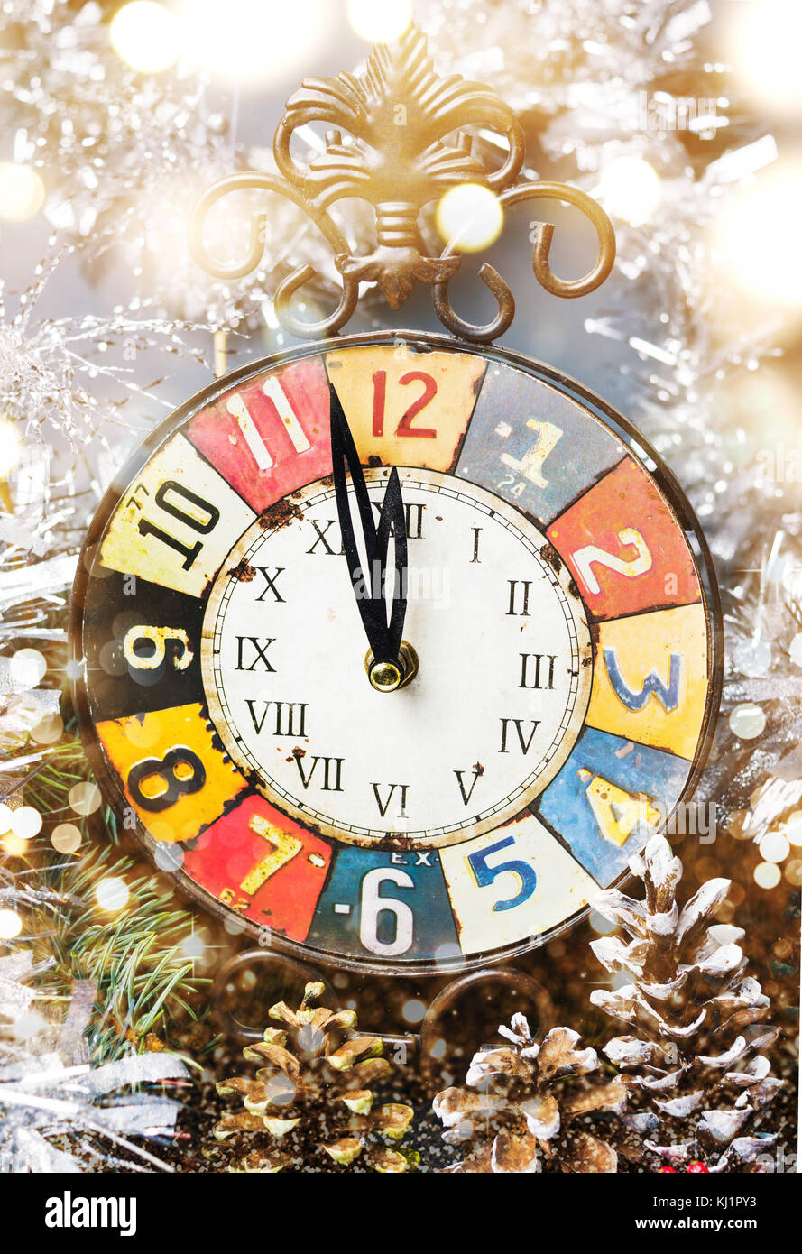 Vintage clock approaching midnight and festive Christmas decorations Stock Photo