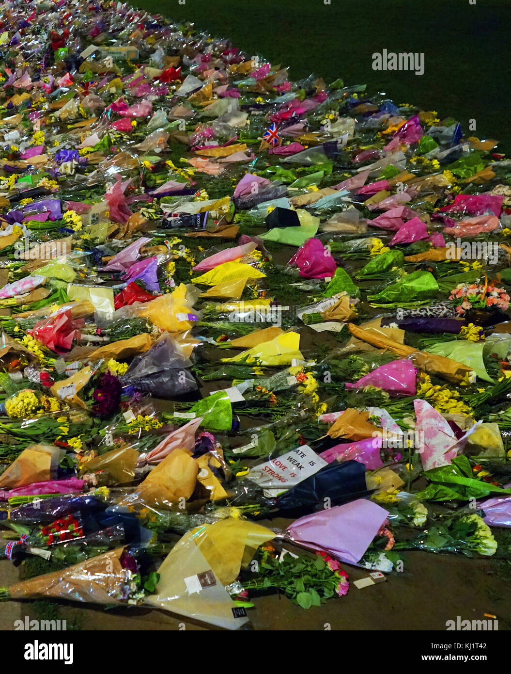 Flowers and tributes decorate Parliament green opposite the British Parliament in London, after the 21 March 2017, terrorist attack, on Westminster Bridge, and Parliament. The attacker drove a vehicle into pedestrians on Westminster Bridge and a crowd of people near Stock Photo