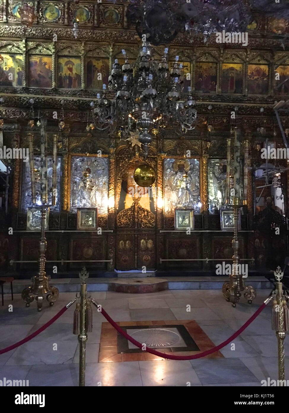 Restored altar in the Church of the Nativity; Bethlehem, in the West Bank, Palestine. The church was originally commissioned in 327 by Constantine the Great and his mother Helena over the site that was traditionally considered the birthplace of Jesus. The Church of the Nativity site's original basilica was completed in 339 and destroyed by fire during the Samaritan Revolts in the 6th century. A new basilica was built 565 by Justinian, the Byzantine Emperor, restoring the architectural tone of the original. Stock Photo