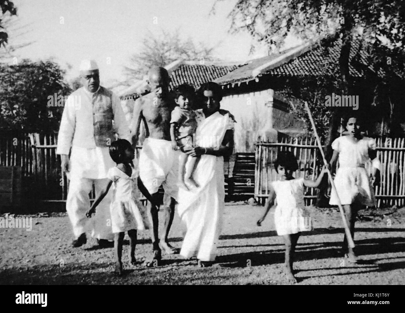 Mahatma Gandhi walking with his grand daughter in law Saraswati ; her son Shanti and others at Sevagram Ashram ; 1940 Stock Photo