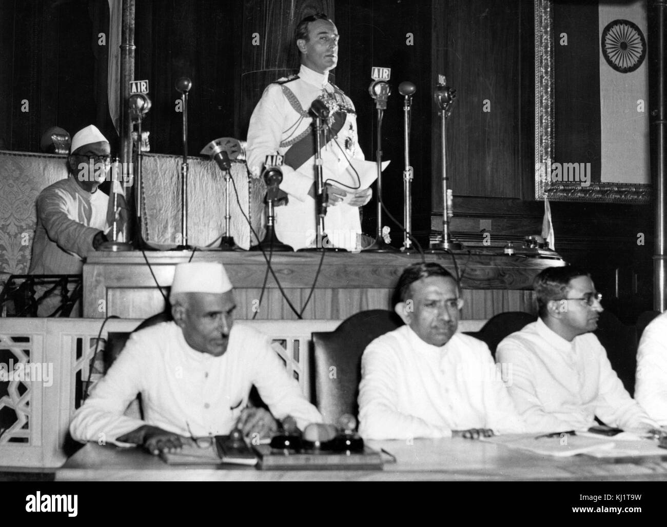 Nehru listens as the Viceroy of India, Lord Mountbatten; declares India's Independence 1947. Jawaharlal Nehru (1889 –1964) first Prime Minister of India and a central figure in Indian politics before and after independence. leader of the Indian independence movement under the tutelage of Mahatma Gandhi and ruled India from its establishment as an independent nation in 1947 until his death in 1964. Stock Photo