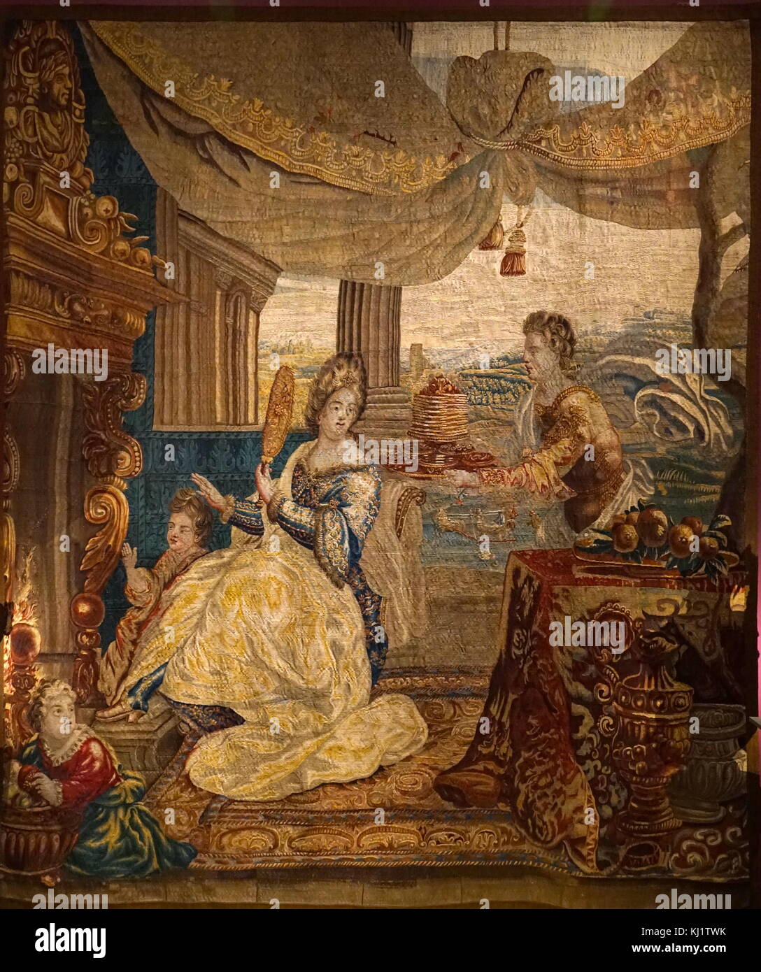 Tapestry titled 'Winter' designed by Lodewijk van Schoor. The tapestry depicts a wealthy woman warming herself by a roaring fire during the winter period. Dated 18th Century Stock Photo