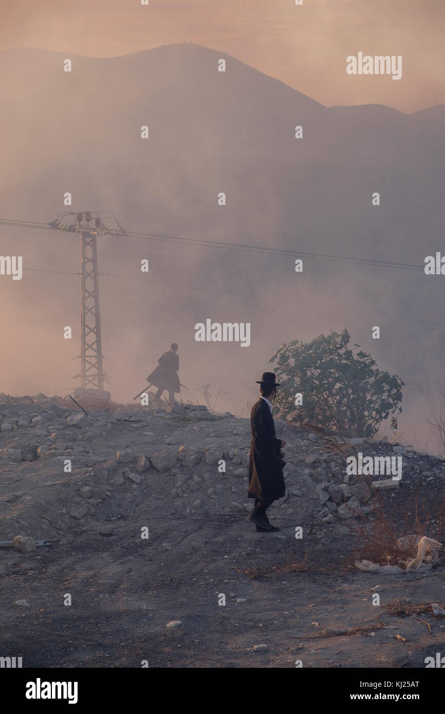 Ultra Orthodox men are watching the fires of Tzfad, Israel Stock Photo