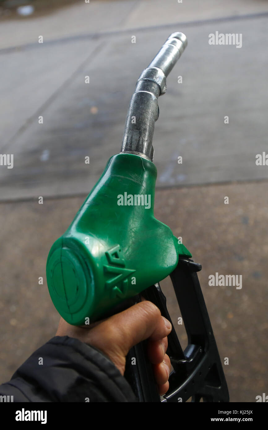 North London. UK 21 Nov 2017 - A driver holding a motor fuel pump in a North London petrol station forecourt as Britain's Chancellor of the Exchequer Philip Hammond is expected to announce an increase in motor fuel tax in his autumn budget on Wednesday, 22 November 2017. Stock Photo