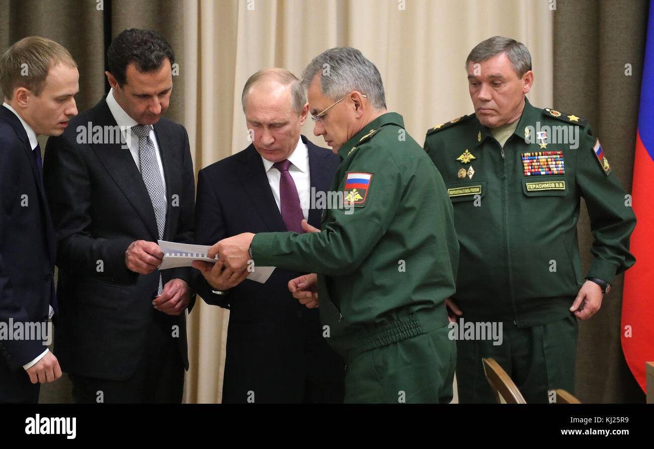 Sochi, Russia. 20th Nov, 2017. Russian Defense Minister Sergei Shoigu, center, shows a document to Russian President Vladimir Putin, center, and Syrian President Bashar Assad, left, during a meeting at the Bocharov Ruchei residence November 20, 2017 in Sochi, Russia. Russian Military Chief Gen. Valery Gerasimov, right, looks on. Credit: Planetpix/Alamy Live News Stock Photo