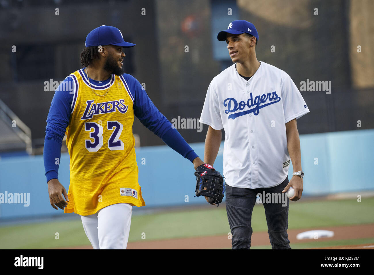 El Segundo, California, USA. 23rd June, 2017. Dodgers pitcher Kenley Jansen,  wearing a Lakers jersey, shares a moment with Lakers draft pick Lonzo Ball  after he threw out the first pitch at