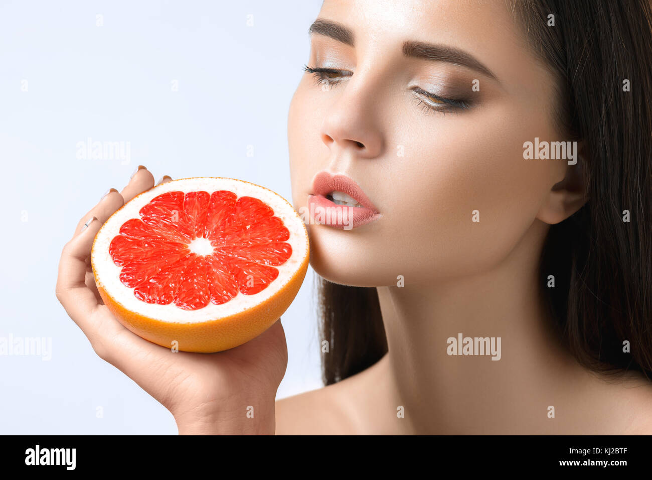 Pretty woman with delicious grapefruit in her arms Stock Photo Alamy