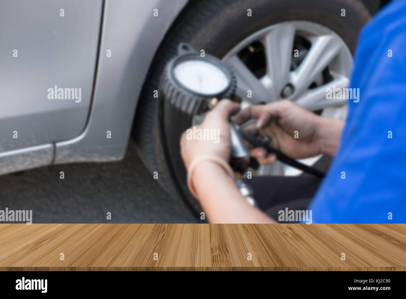Tire Inflator. mechanic holding gauge for car tyre pressure measurement ...