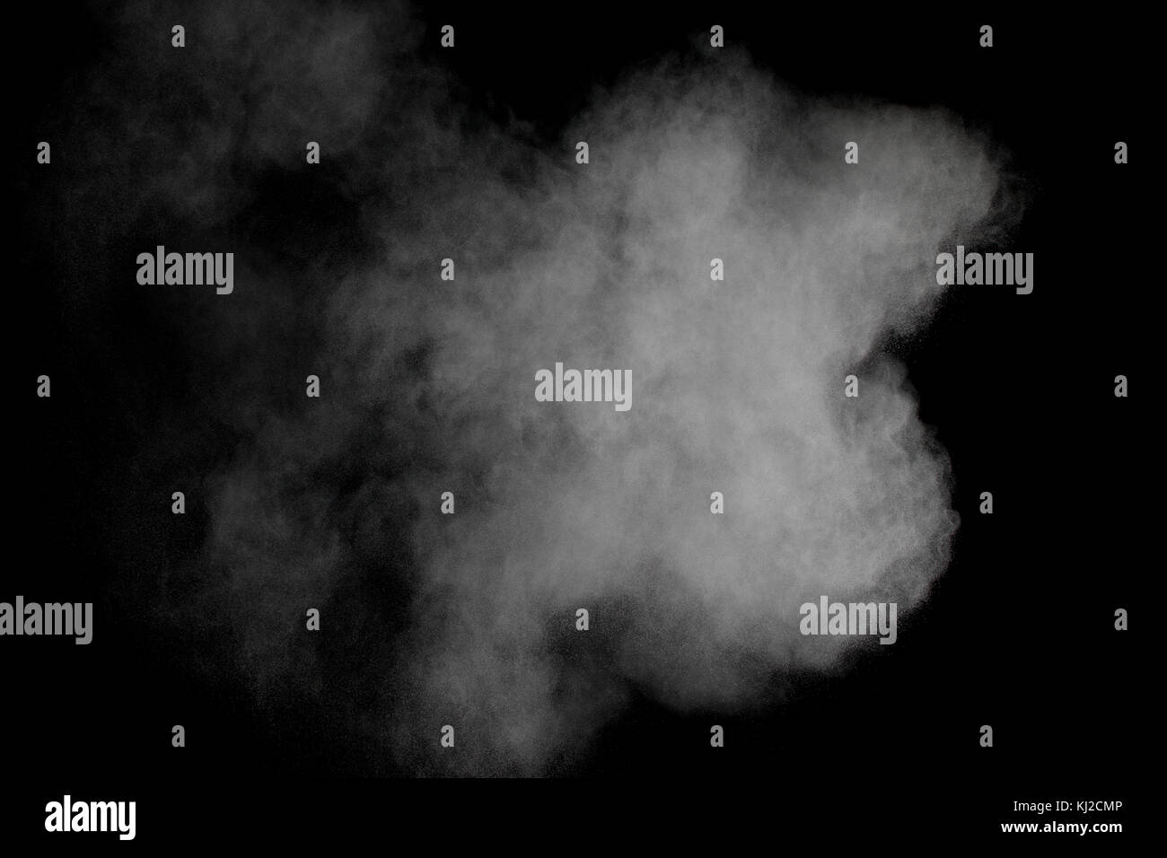 Launched white powder isolated on black background Stock Photo - Alamy