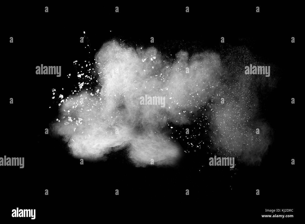 Launched white powder isolated on black background Stock Photo - Alamy
