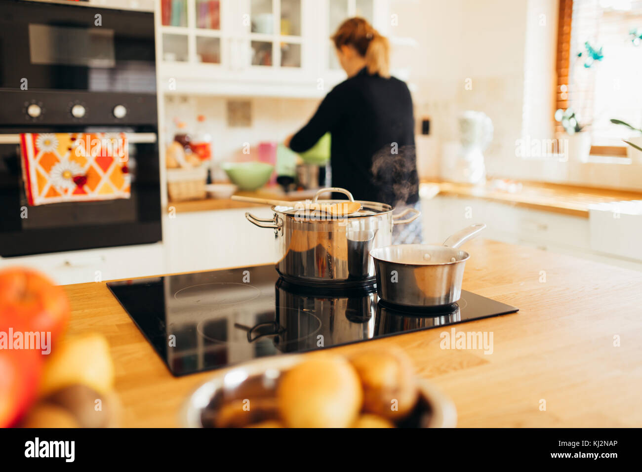 Housewife making lunch in kitchen Stock Photo