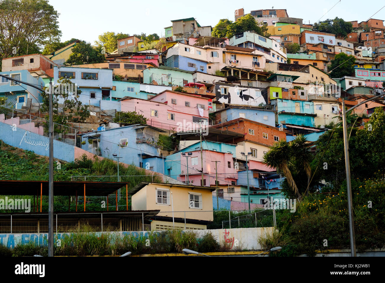 Venezuela, Santiago de Len de Caracas: shanty towns in the upper city with a mural depicting 'the eyes of Hugo Chavez', campaign poster used by Madur Stock Photo