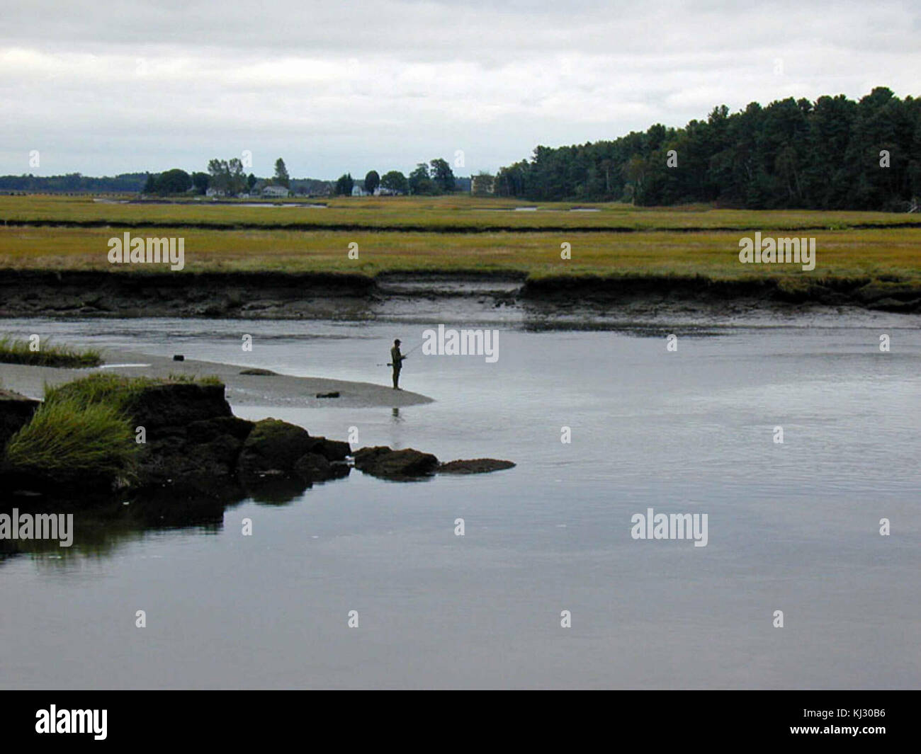 Silhouette of the fisherman on the water in the distance Stock Photo ...