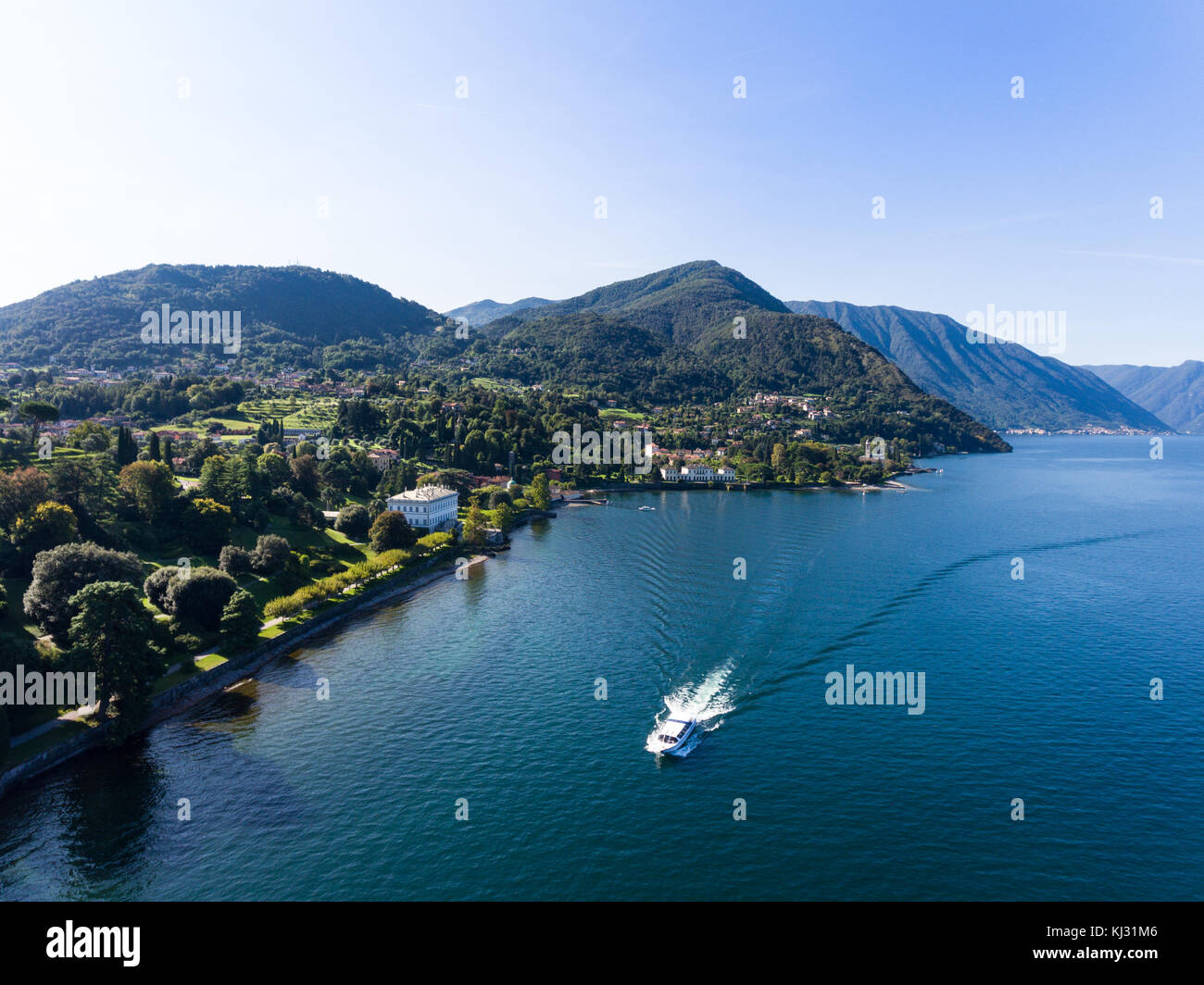 Boat and luxury home on Como lake in Italy, Villa Melzi - Bellagio Stock Photo
