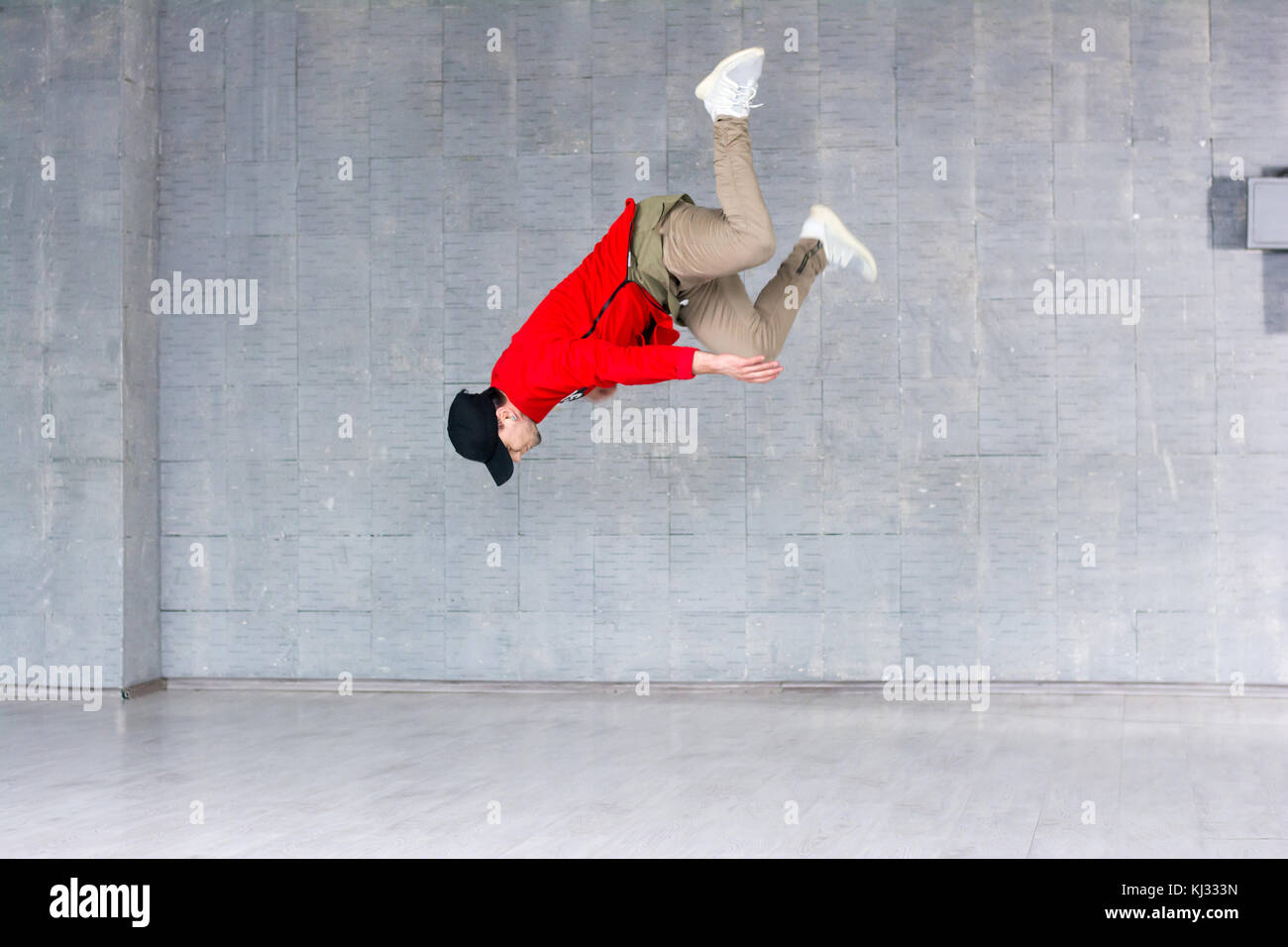 Rap dancer jumping on grey background Stock Photo - Alamy
