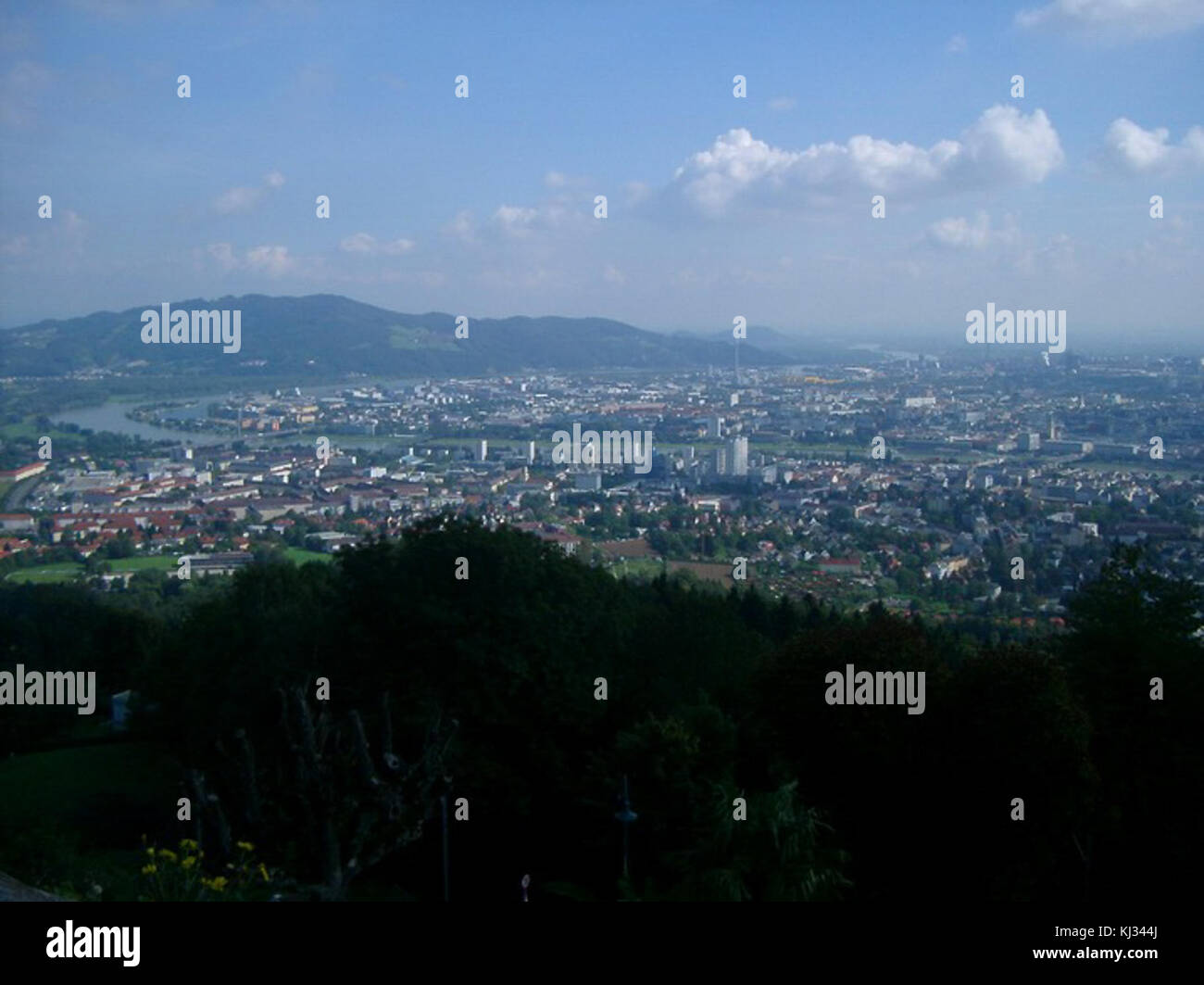 This photograph shows a panoramic view of Linz, Austria. The city ...