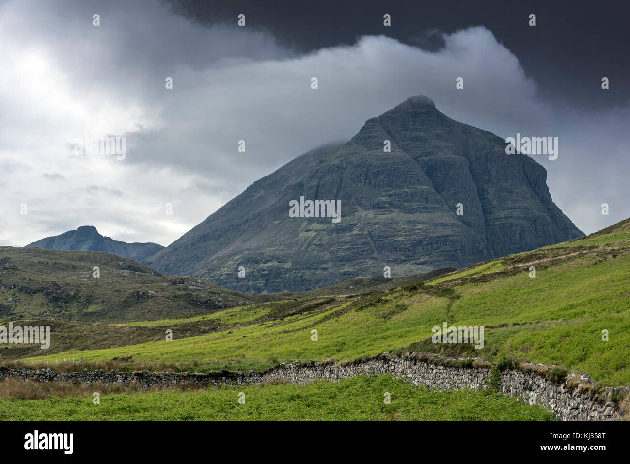 Dark rain clouds over the mountain top Sàil Gharb, one Quinag's three separate Corbett summits in the Scottish Highlands, Sutherland, Scotland, UK Stock Photo