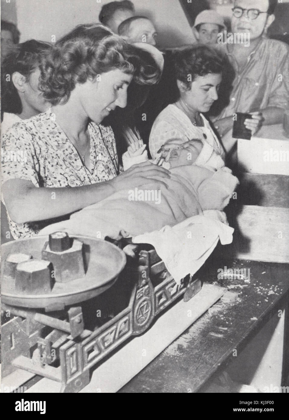 Israel 47022 mother weights baby at