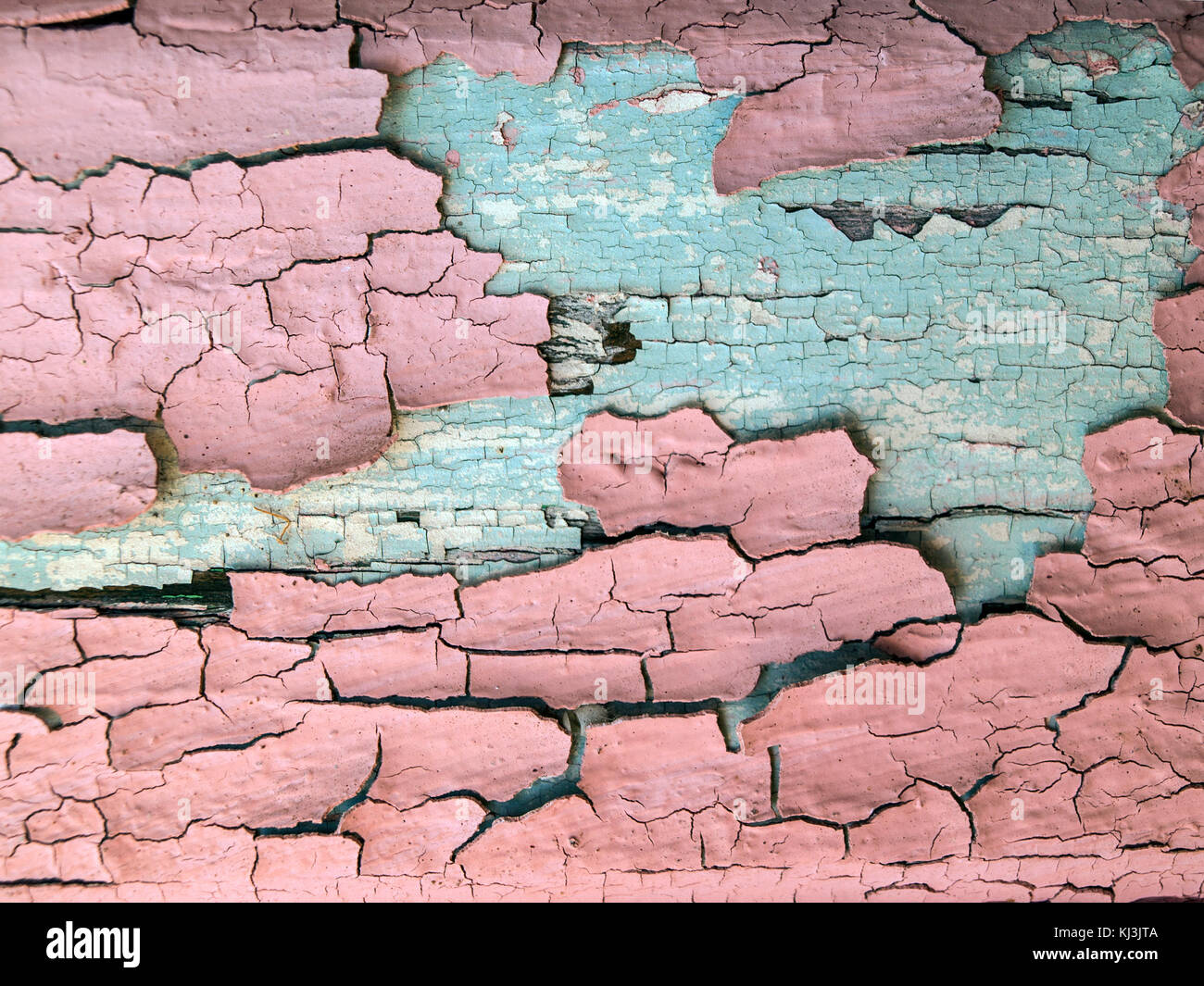 Old peeling pink paint with cracks and old cyan paint Stock Photo