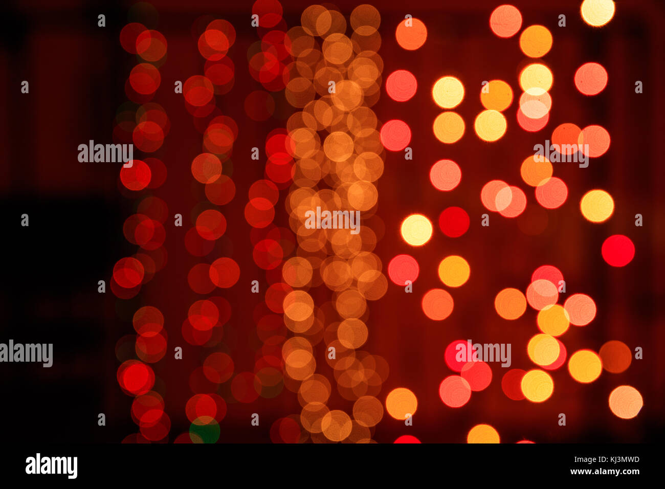 Christmas lights bokeh background. Orange, yellow and red lights on dark background Stock Photo