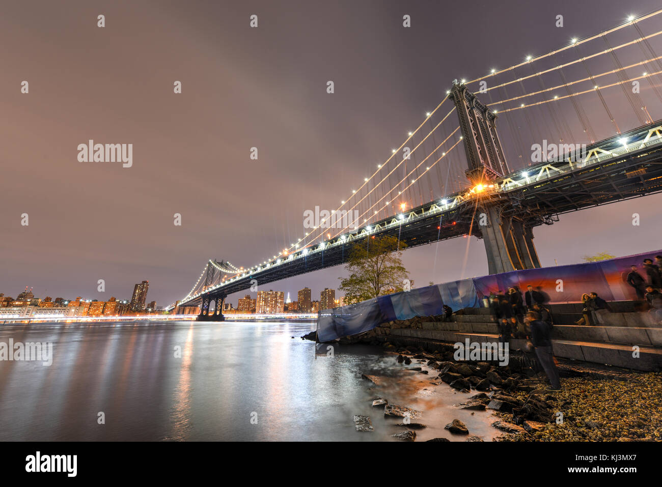 BROOKLYN, NEW YORK - NOVEMBER 8, 2014: Brooklyn Bridge at night viewed from the Brooklyn Bridge Park in New York City. Stock Photo