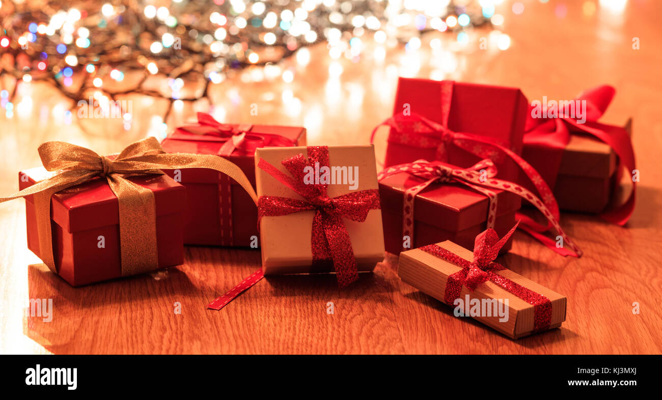 Gift boxes on wooden floor on Christmas lights bokeh background Stock Photo