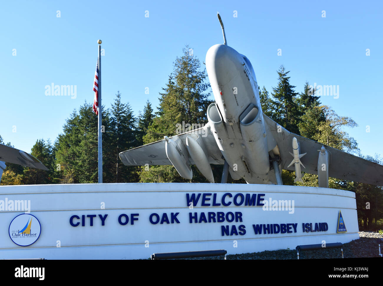 Two Navy fighter jets with bombs underneath welcome visitors to Oak Harbor on Whidbey Island in Washington State. Stock Photo
