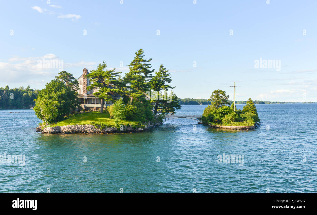 The smallest international bridge connecting two of Thousand Islands on Saint Lawrence River - one island is USA and other is Canada. Stock Photo