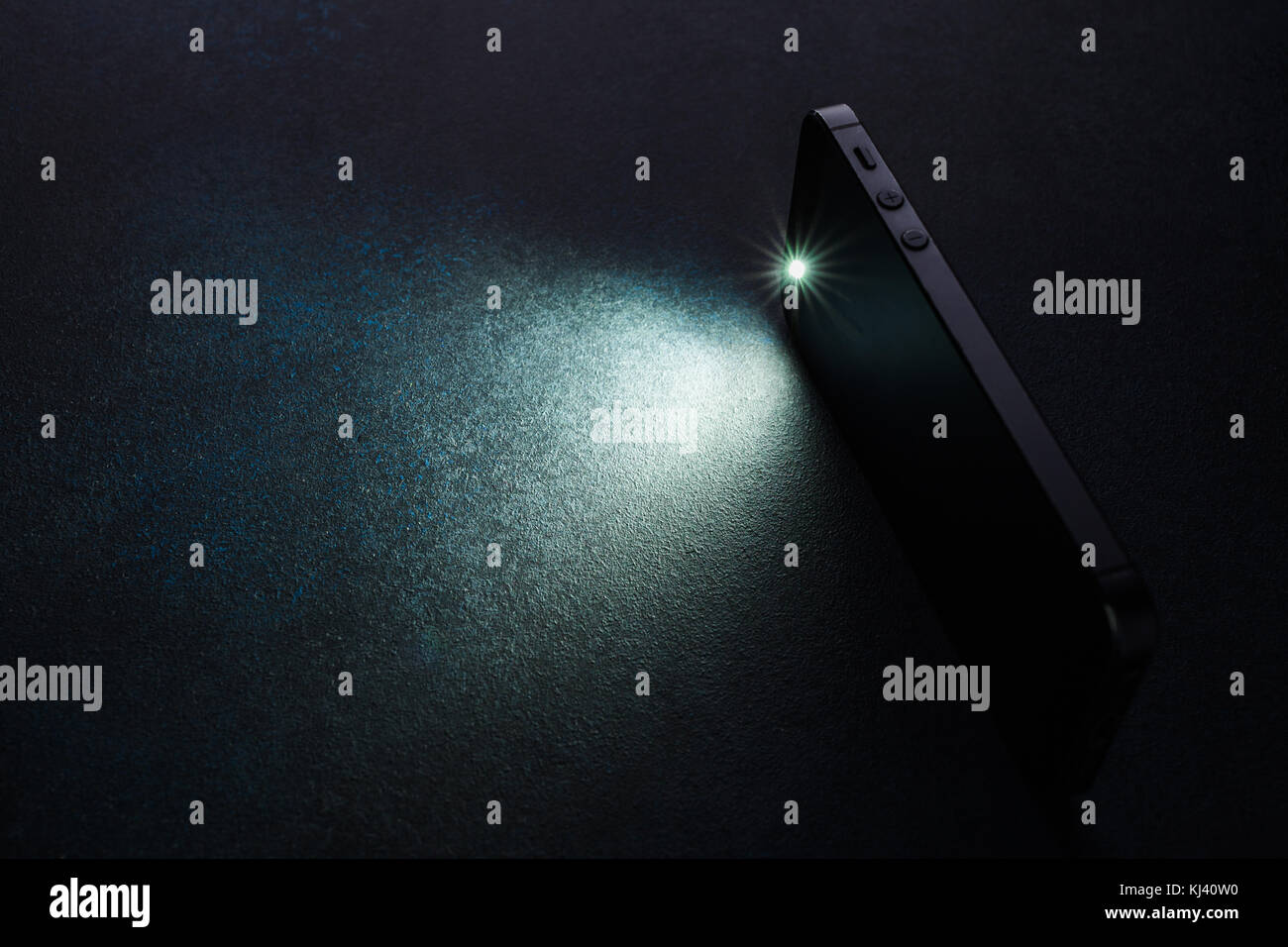 Lantern smartphone shines on a dark background Stock Photo - Alamy