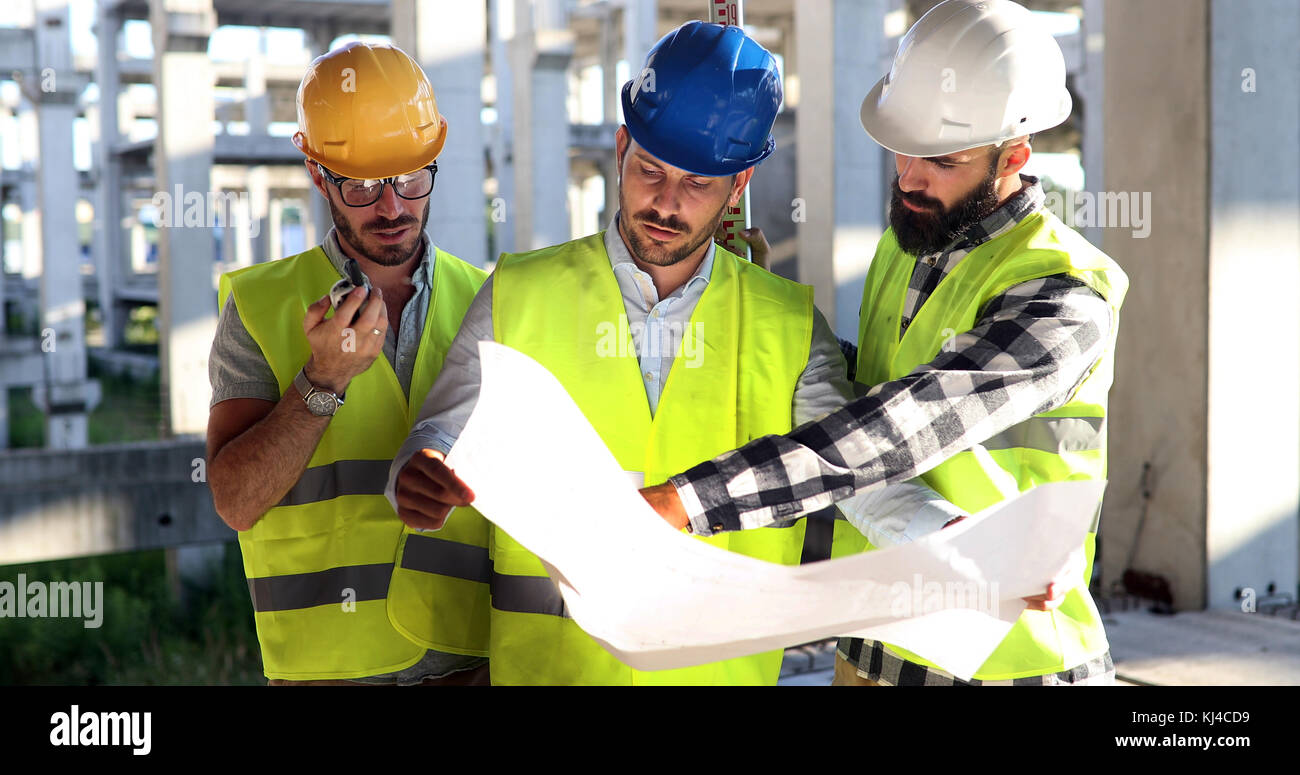 Construction engineers discussion with architects at construction site Stock Photo