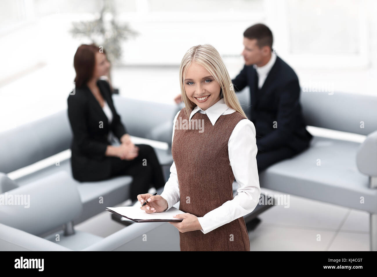 woman assistant standing in the lobby of the modern office .photo with ...