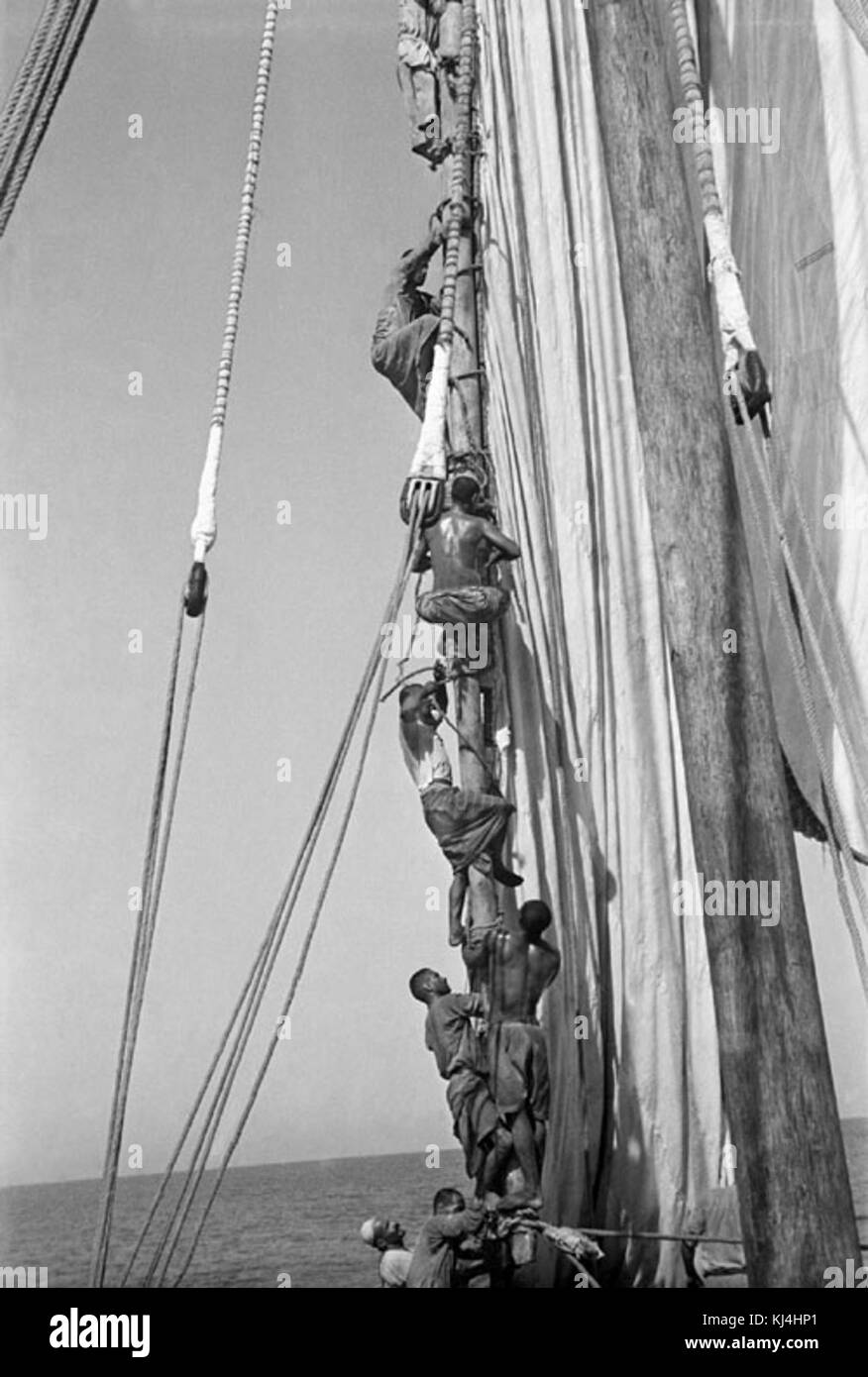 Dhow - crew climbing aloft on a mast Stock Photo