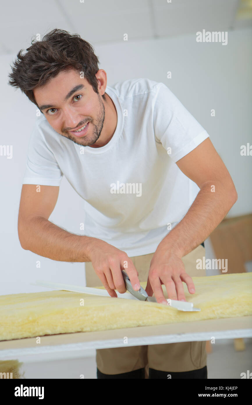 plasterer cutting a foam Stock Photo
