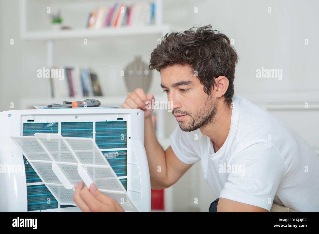 Man assembling air conditioning unit Stock Photo