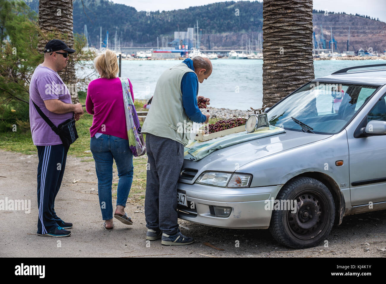 Man selling cherries on a beach promenade in Bar coastal town in southern Montenegro Stock Photo