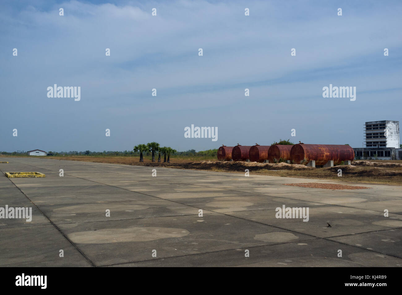 This airport was built by Khmer Rouge near Kampong Chhnang, in Cambodia. This airport has one concrete runway and few buildings. Today only buffalo of Stock Photo