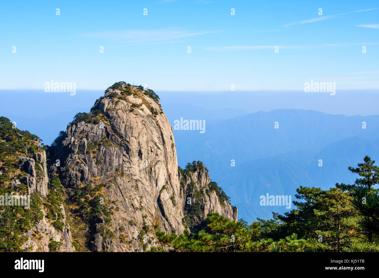 Big Granite boulder with rolling hills in the background on Yellow Mountain in China Stock Photo