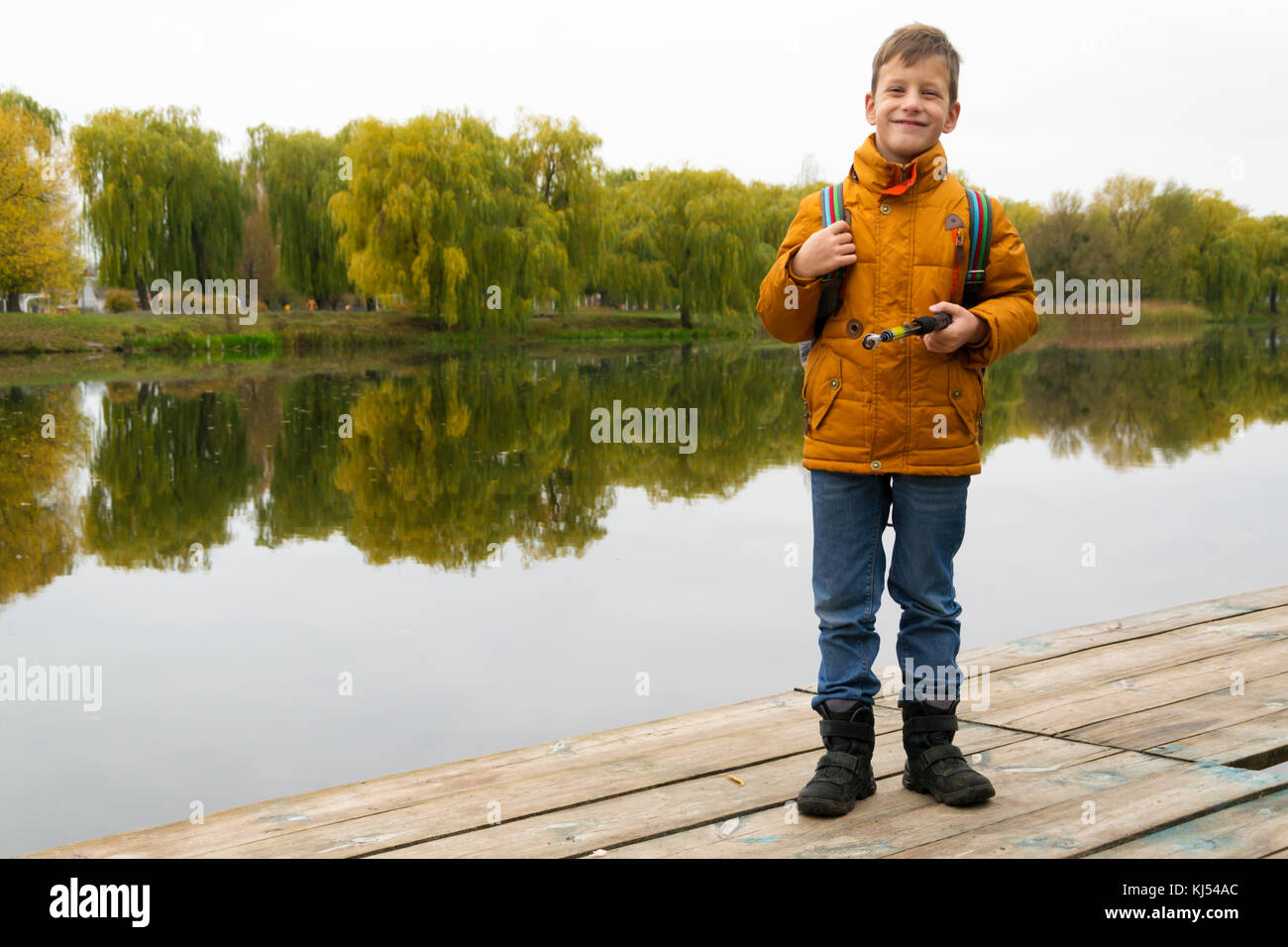Child fishing on dock pond hi-res stock photography and images - Alamy