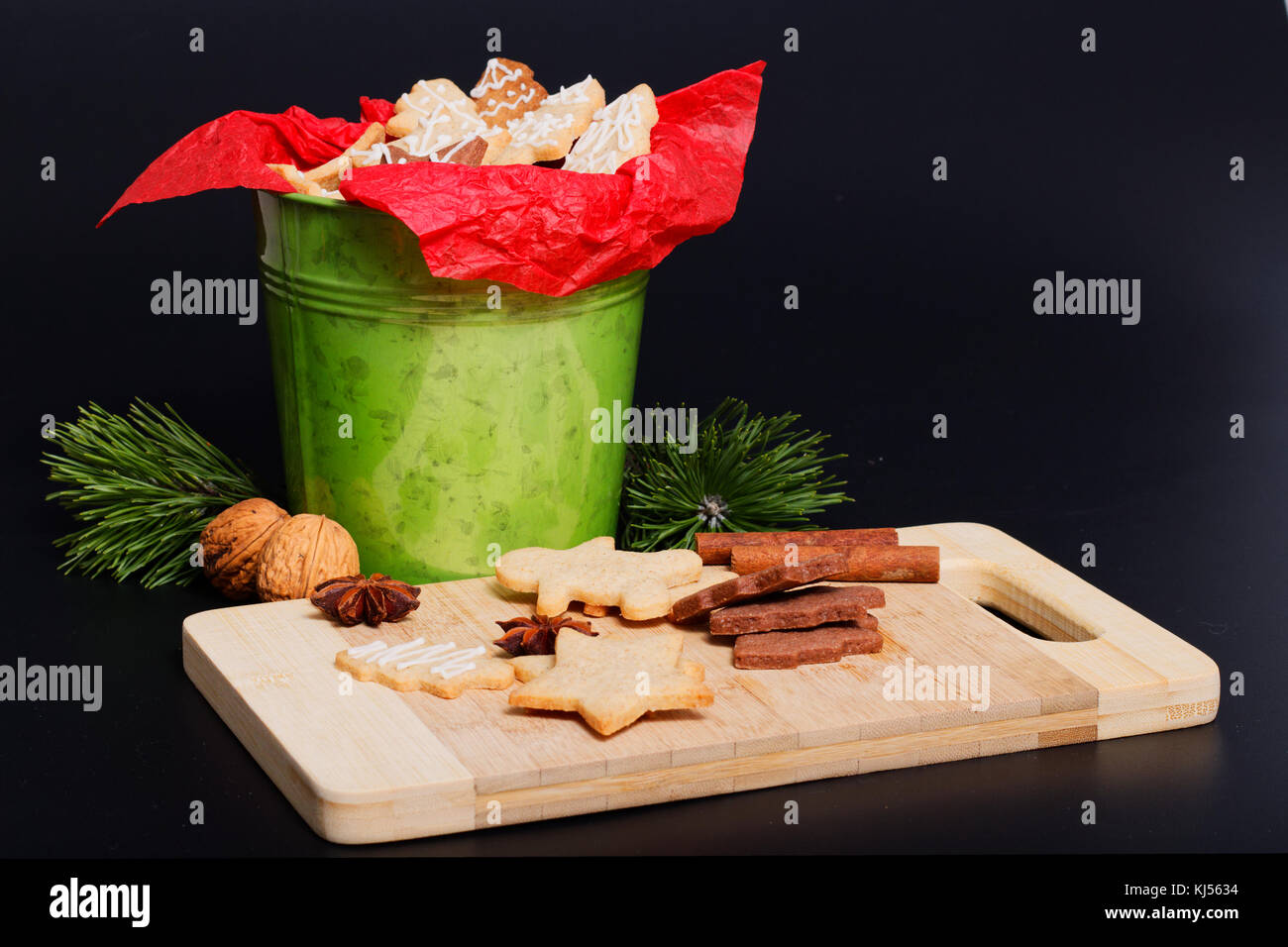 Idea DIY Do it yourself new year and Christmas gift concept butter sugar cookies with royal icing decoration in green bucket with copy space Stock Photo